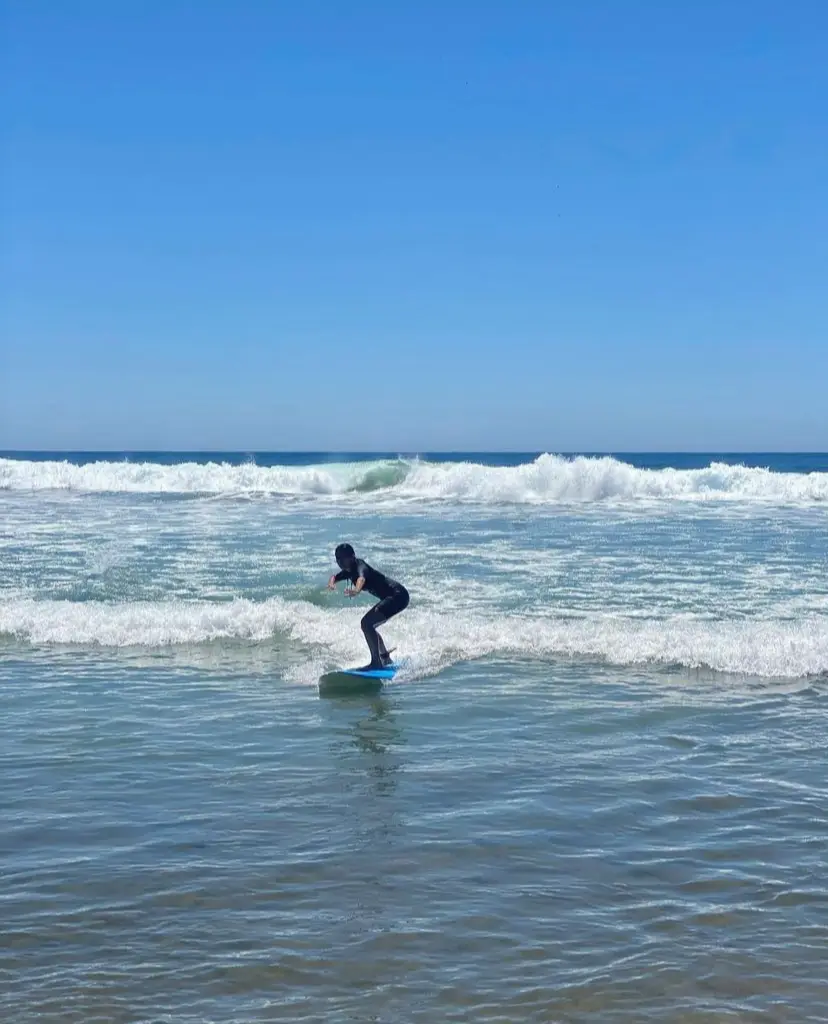Surfer catching a small wave in Cerritos Beach. 