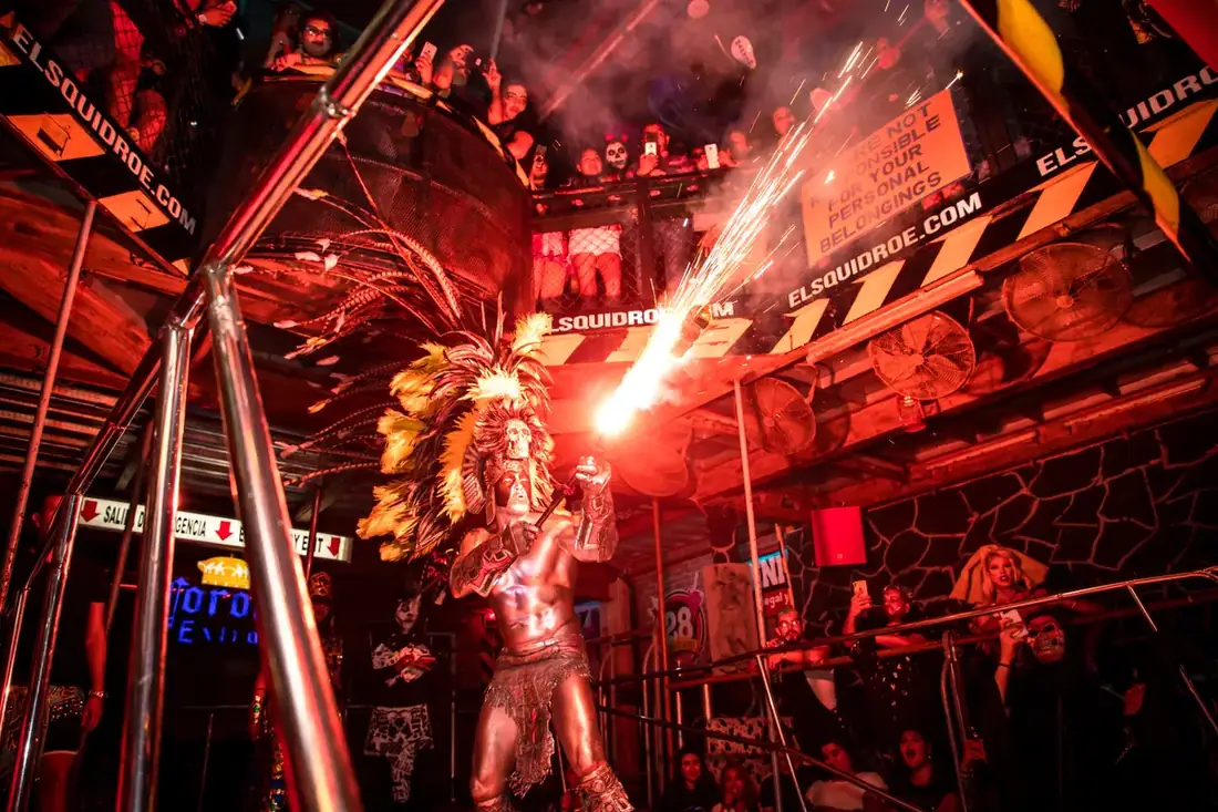Man dressed up as an Aztec with a flame thrower at El Squid Roe in Cabo, Mexico. 