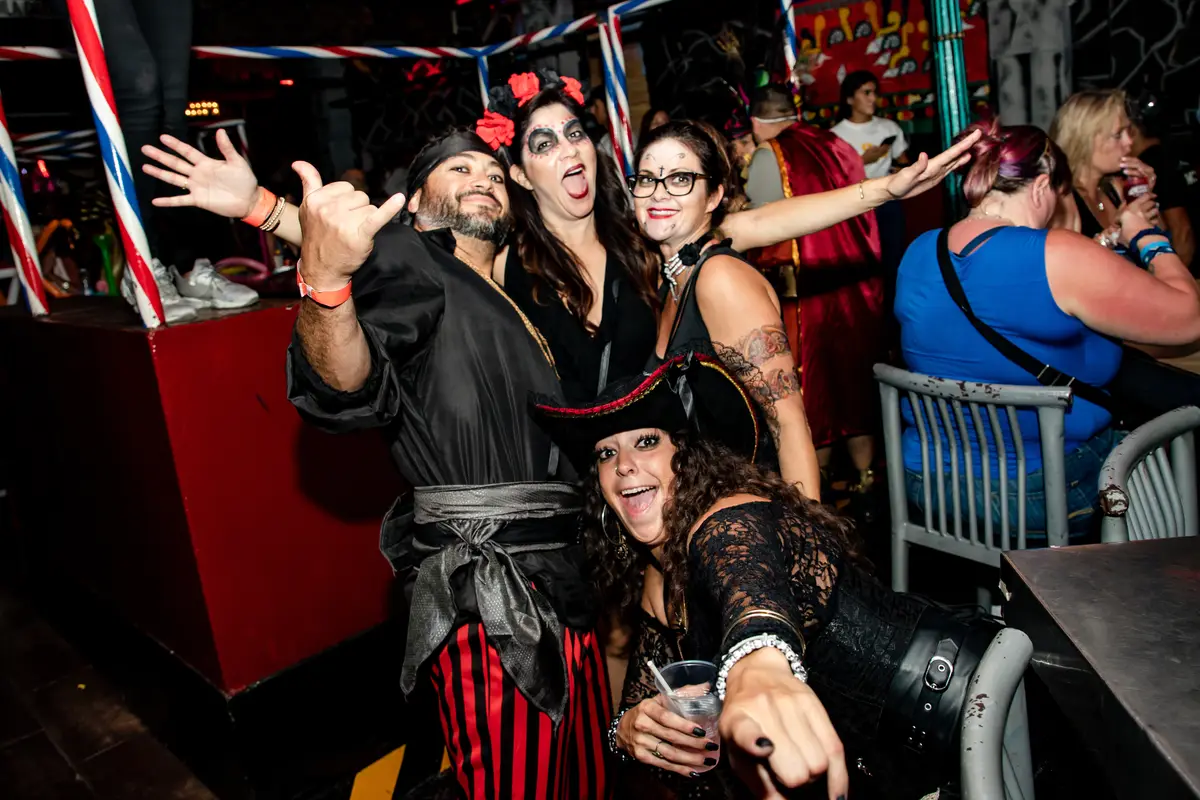 Group of friends dressed as pirates celebrating Halloween at El Squid Roe in Cabo, Mexico. 