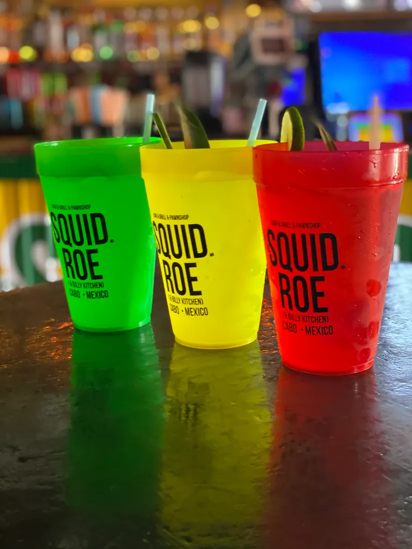 Three cups from El Squid Roe in Cabo. Mexico, from left to right, green, yellow, and red. 