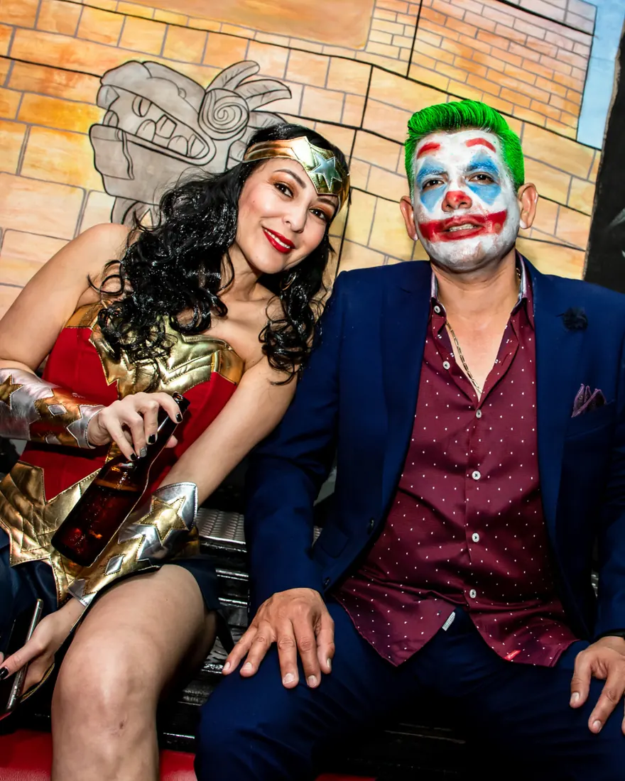 Woman dressed as Wonder Woman and a man dressed as Joker at El Squid Roe's Halloween party in Cabo, Mexico. 