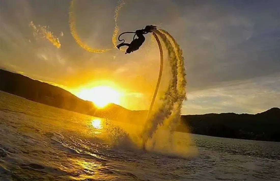 Person doing a backflip on a Flyboard at Medano Beach.