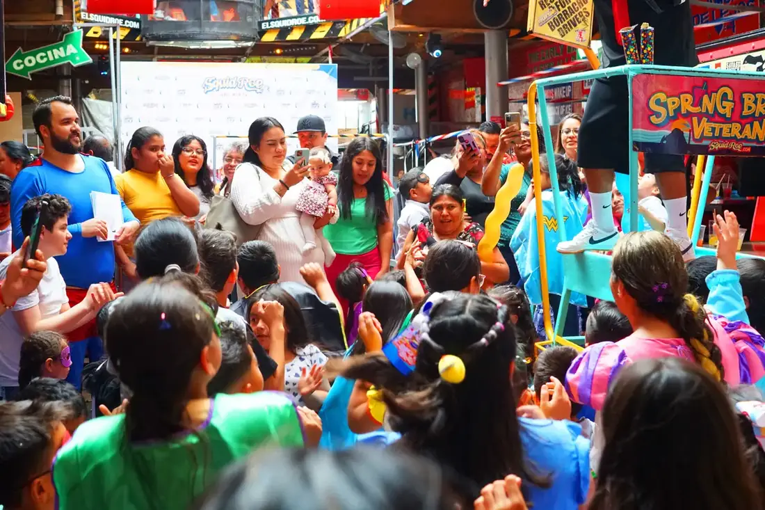 Children dancing at El Squid Roe as their parents take pictures and cheer them on. 
