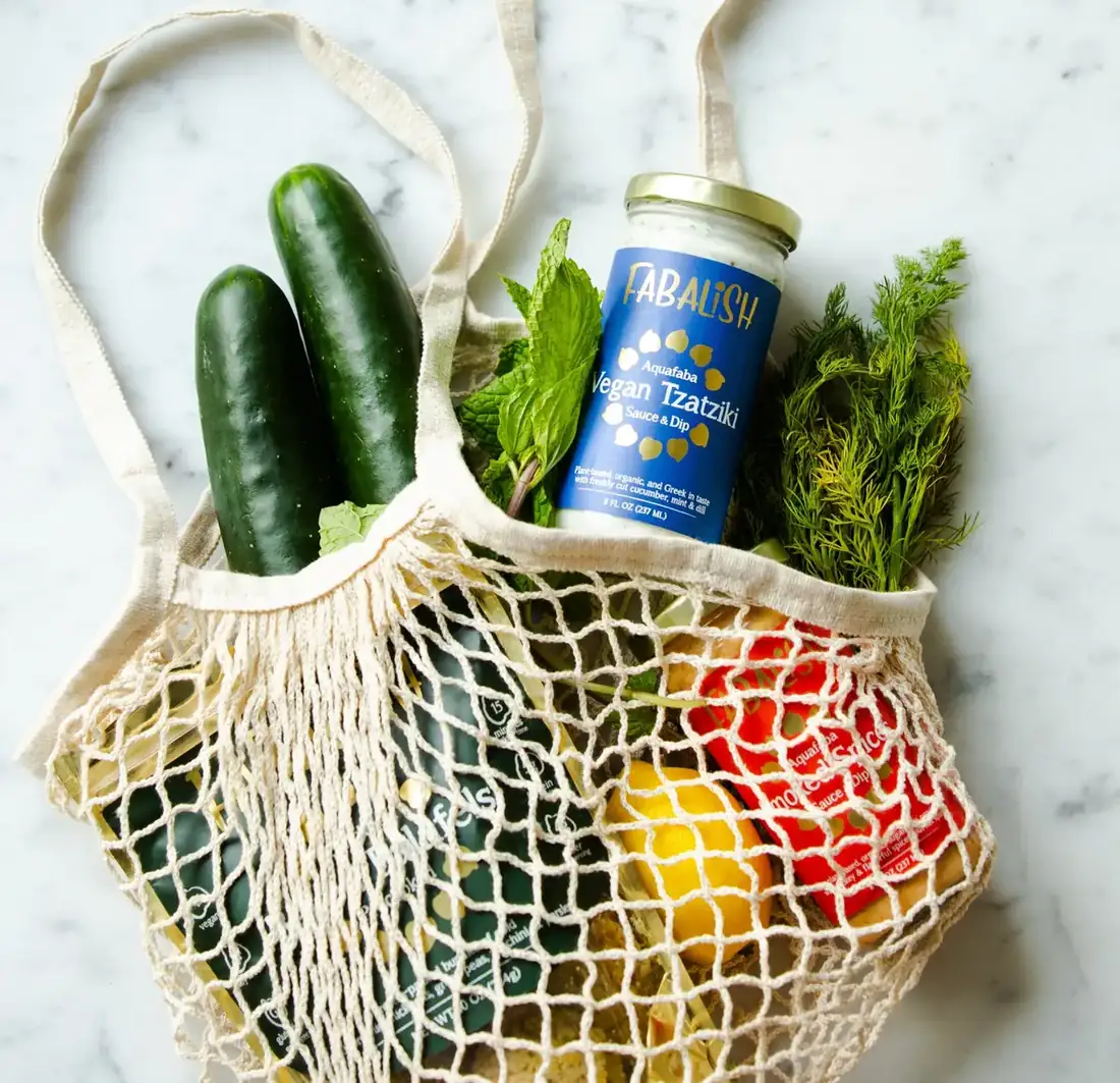 Healthy groceries spilling out of a market bag. 