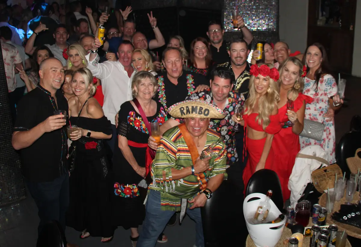 Large group of friends dressed up for the Day of the Dead at The Nowhere Bar in Cabo, Mexico. 
