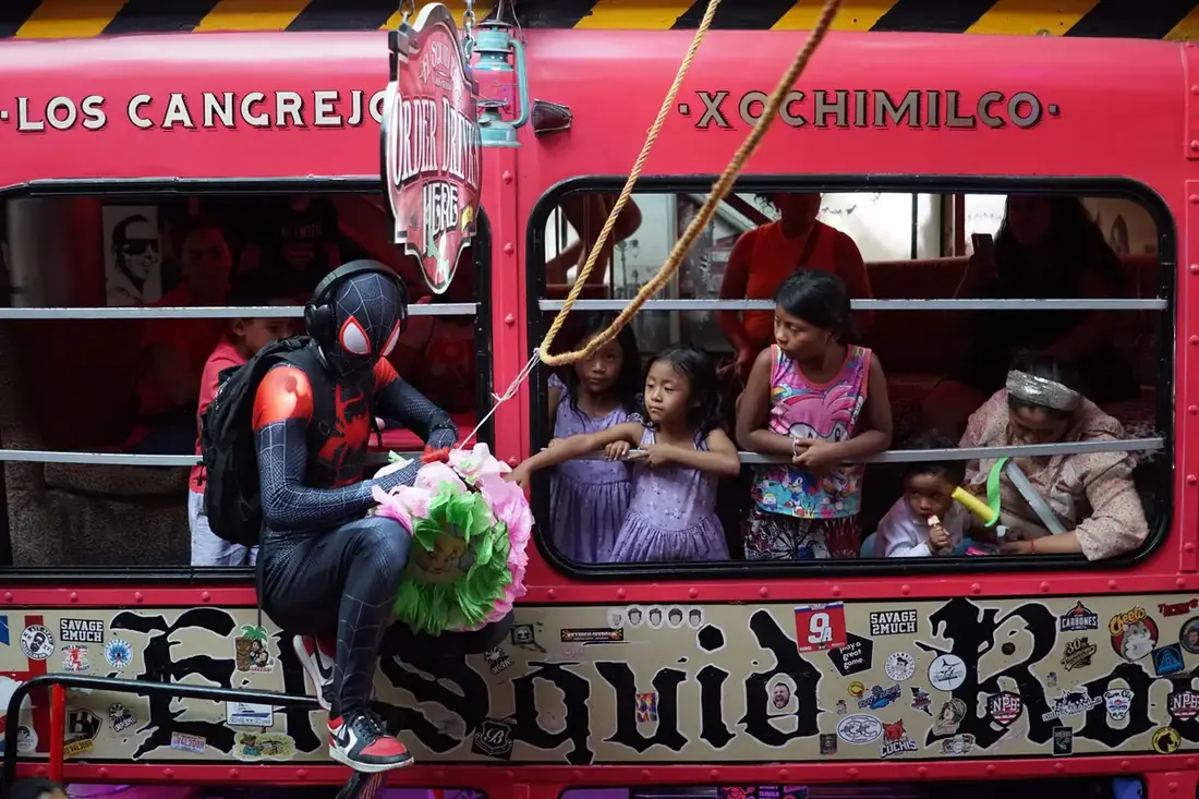 SpiderMan helping break open the piñata at El Squid Roe.