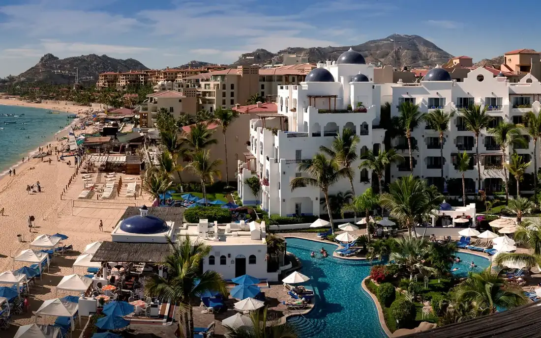 Greek inspired white buildings with blue roofs of Pueblo bonito hotel, next to Medano Beach.