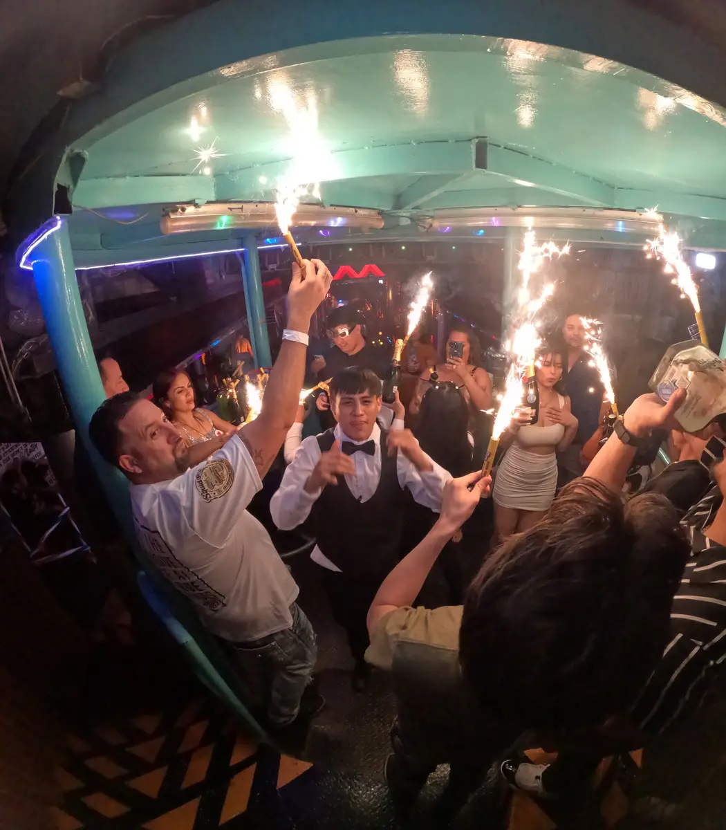 People popping bottles at El Squid Roe in Cabo San Lucas, Mexico on New Year's Eve