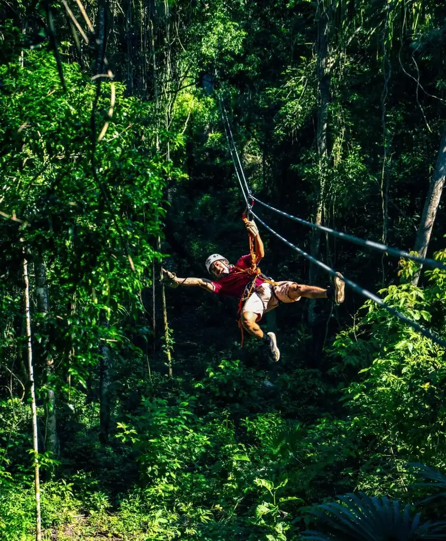 Man enjoying a zip line in Cancun, Mexico. 