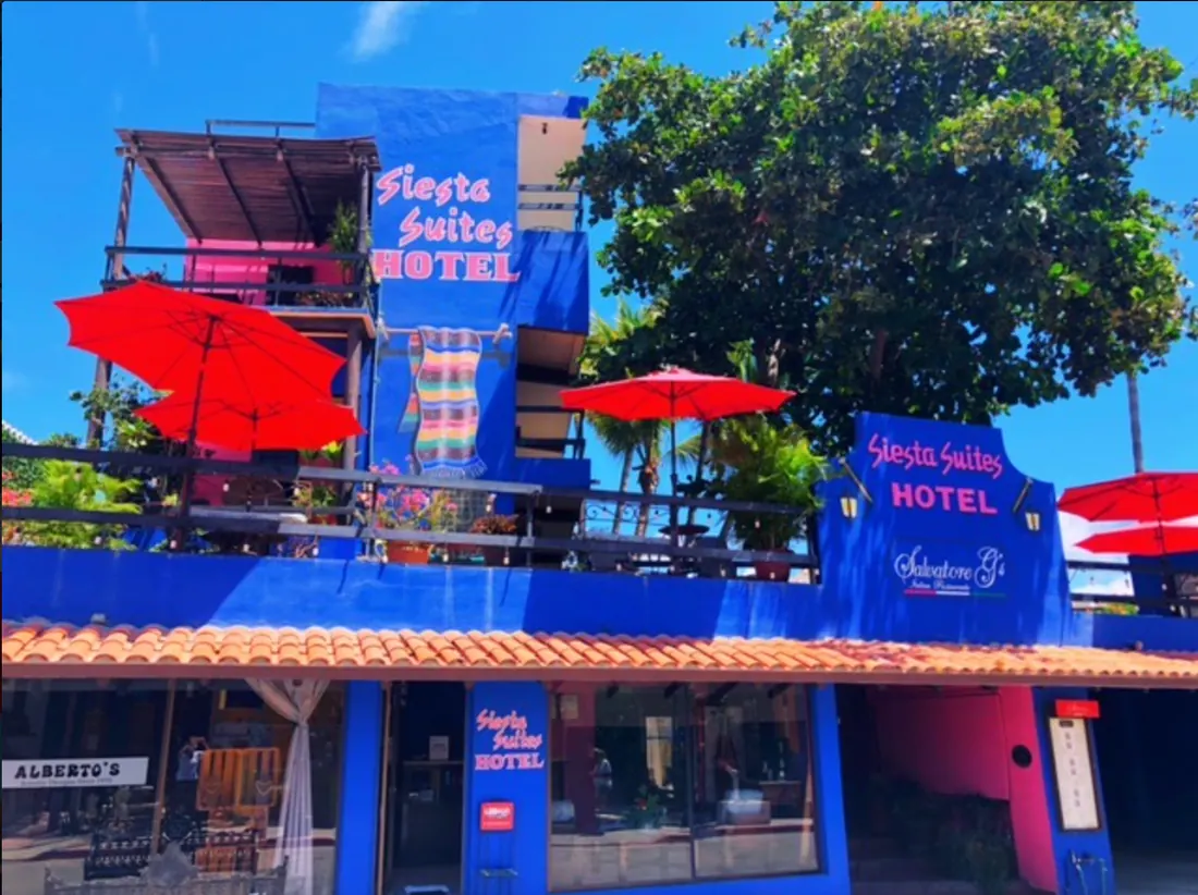 Outside view of Siesta Suite Hotel, painted with a bright, royal blue. 