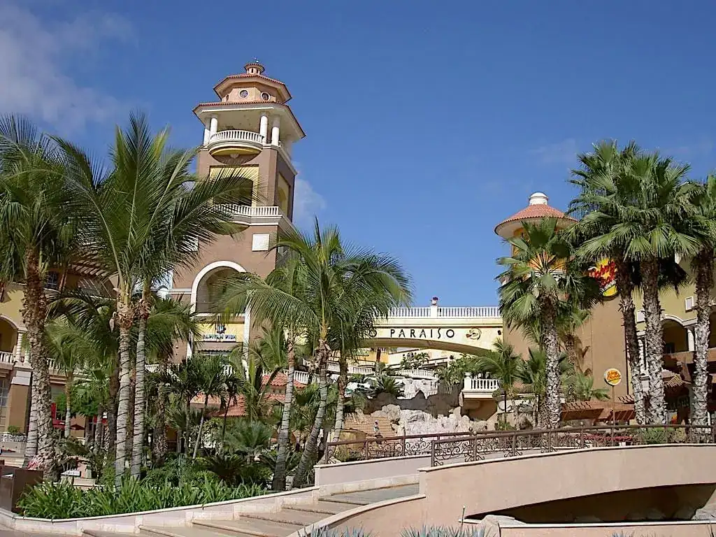 Towers of Puerto Paraiso mall surrounded with palm trees. 