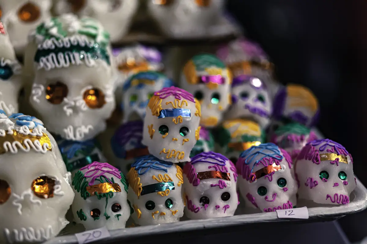 Stack of sugar skulls decorated with fun colors. 