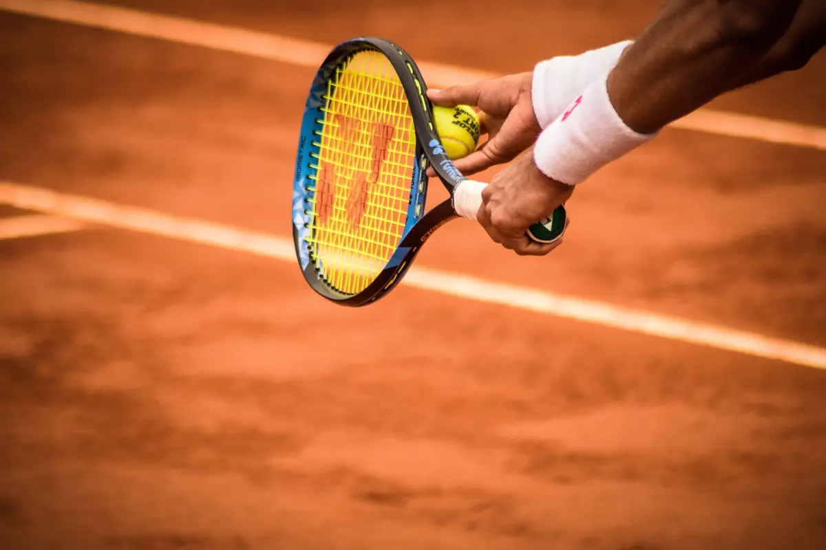 Tennis player serving in a game of tennis.