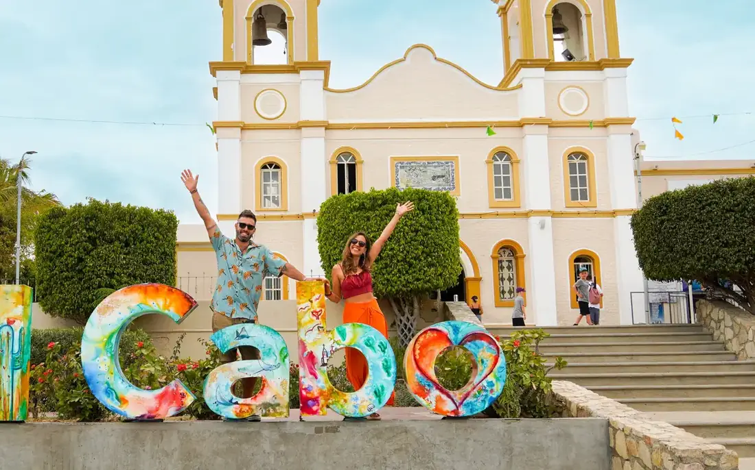 Couple posing by the church of San Jose del Cabo in Mexico.