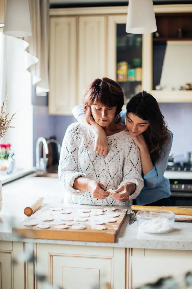 Mother and daughter making cookies.