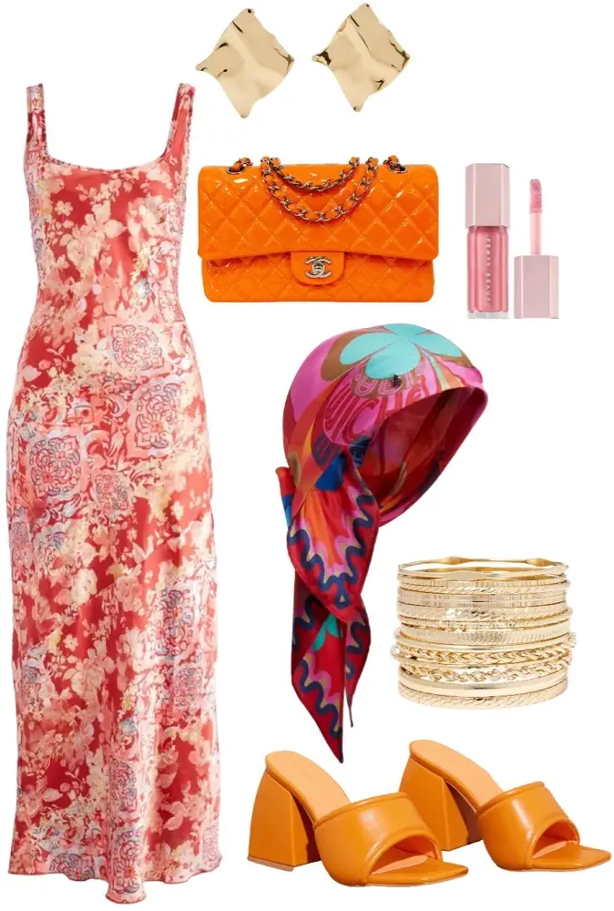 Long satin dress with floral print in shades of red, paired with chunky orange 3 inch heels, and a matching orange purse. Gold statement earrings and bangles. Colorful head scarf with shades of pink and teal. Pink lip gloss on the side.