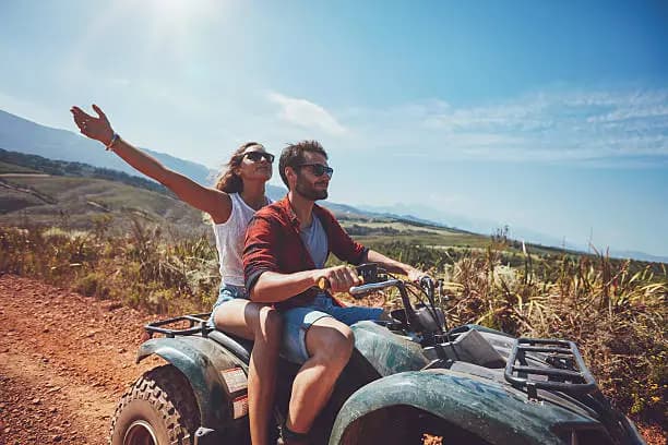 Couple riding an ATV through the Baja desert.