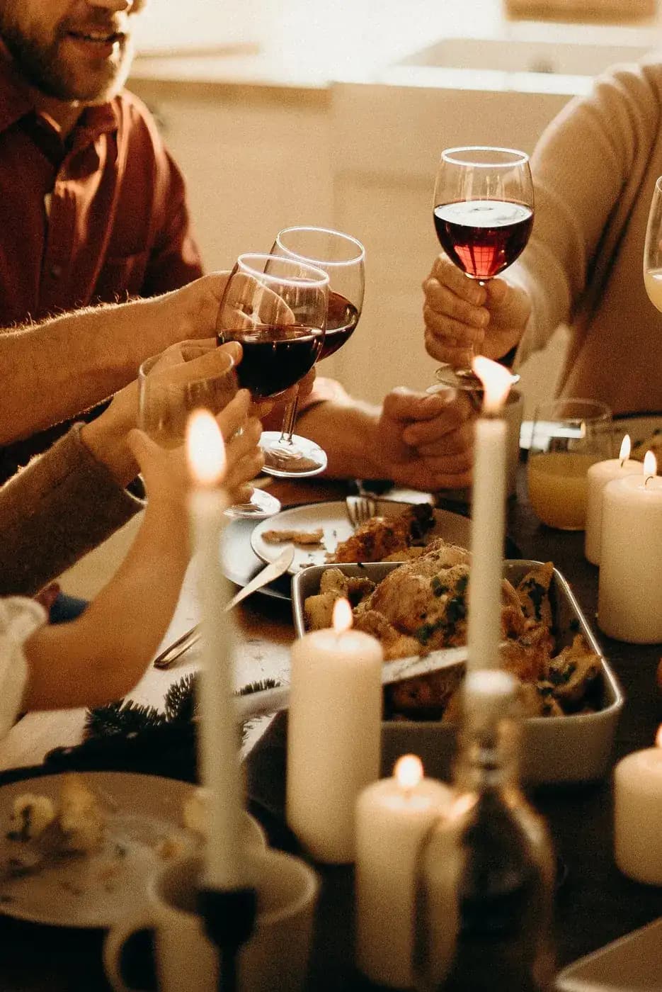 Family toasting over the Thanksgiving dinner table.