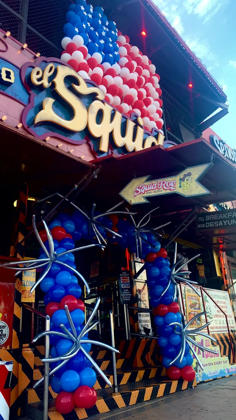 Entrance of El Squid Roe decorated with a balloon arch and an American flag made out of balloons.