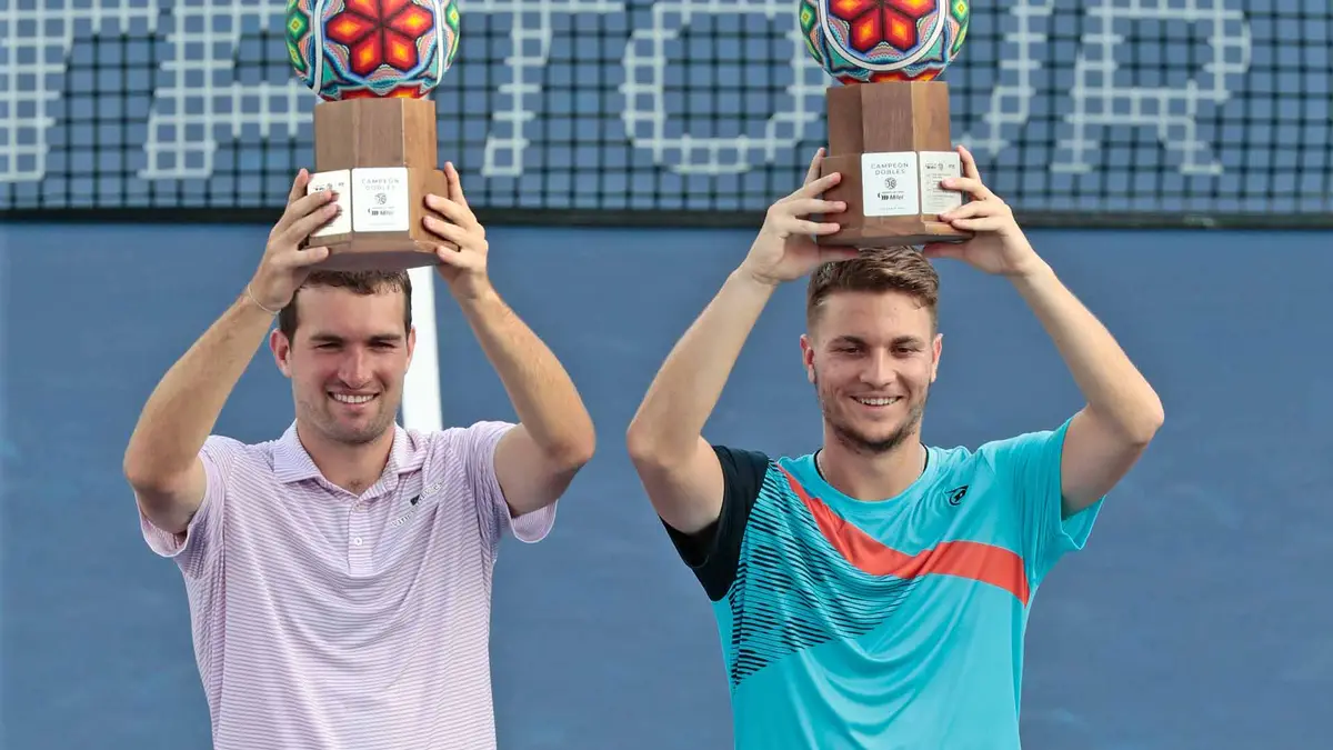 Blumberg and Kecmanović holding their Doubles Trophies.