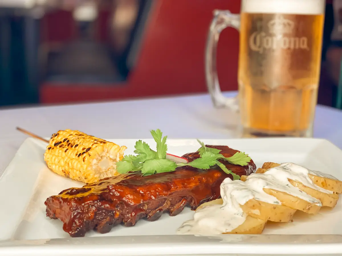 El Squid Roe's Almost Famous Ribs served with potatoes, corn and an ice cold beer.