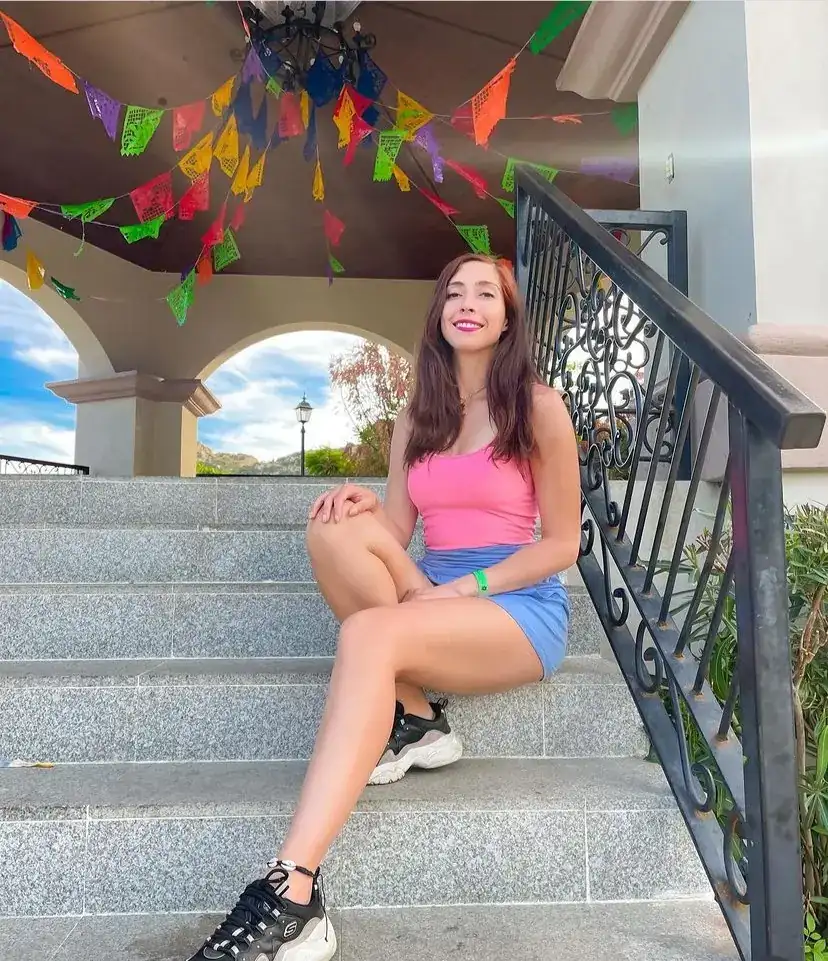 Woman sitting on the steps of the gazebo at the Amelia Wilkens park in Cabo, Mexico.