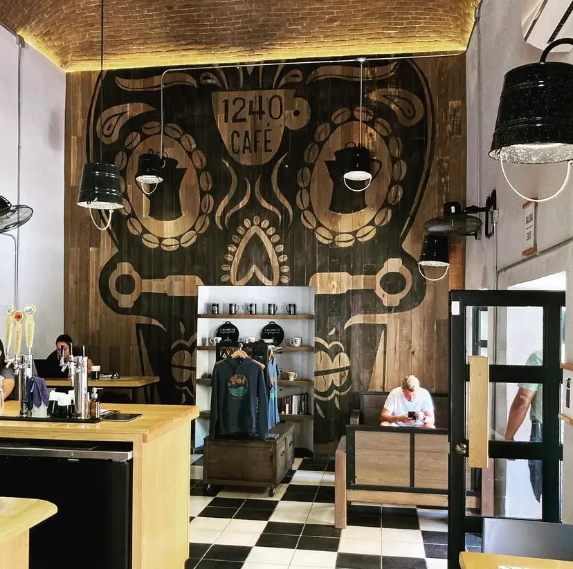 Mural of a Mexican skull with coffee beans surrounding the eyes, in the cafe.
