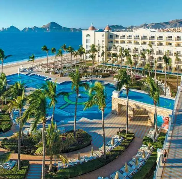 Pool at RIU Palace hotel in Cabo with Medano Beach in the background.