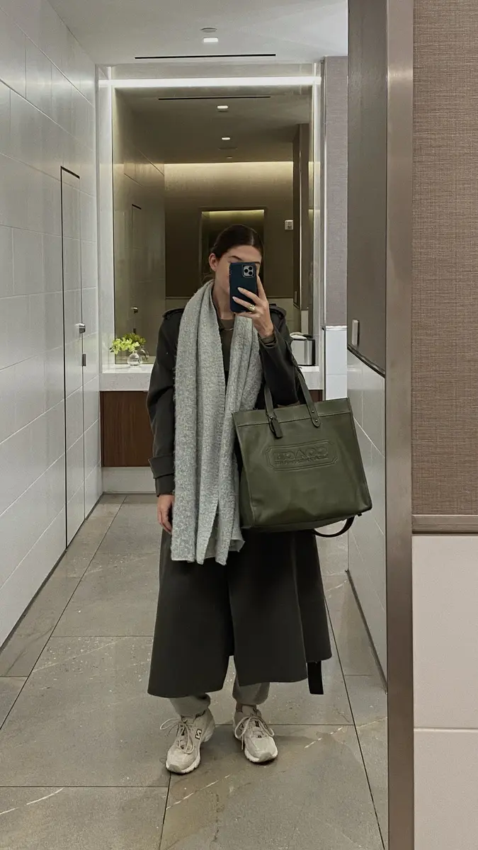 Woman taking a selfie in a lavish airport bathroom.