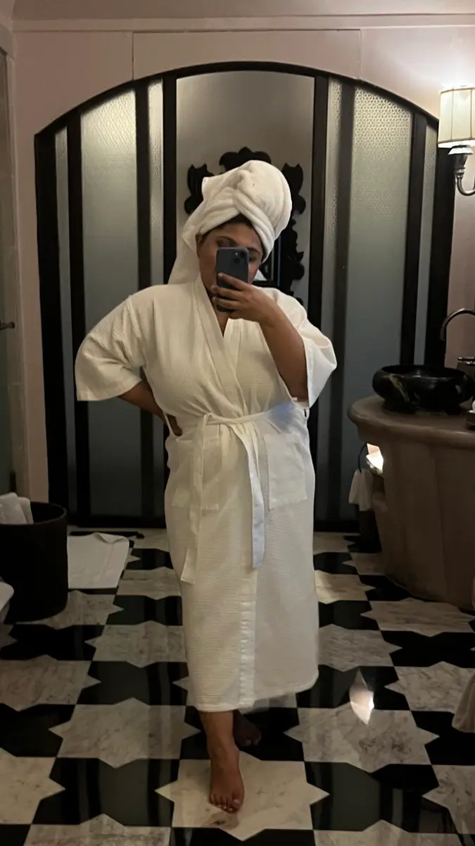 Woman in a robe at a spa.