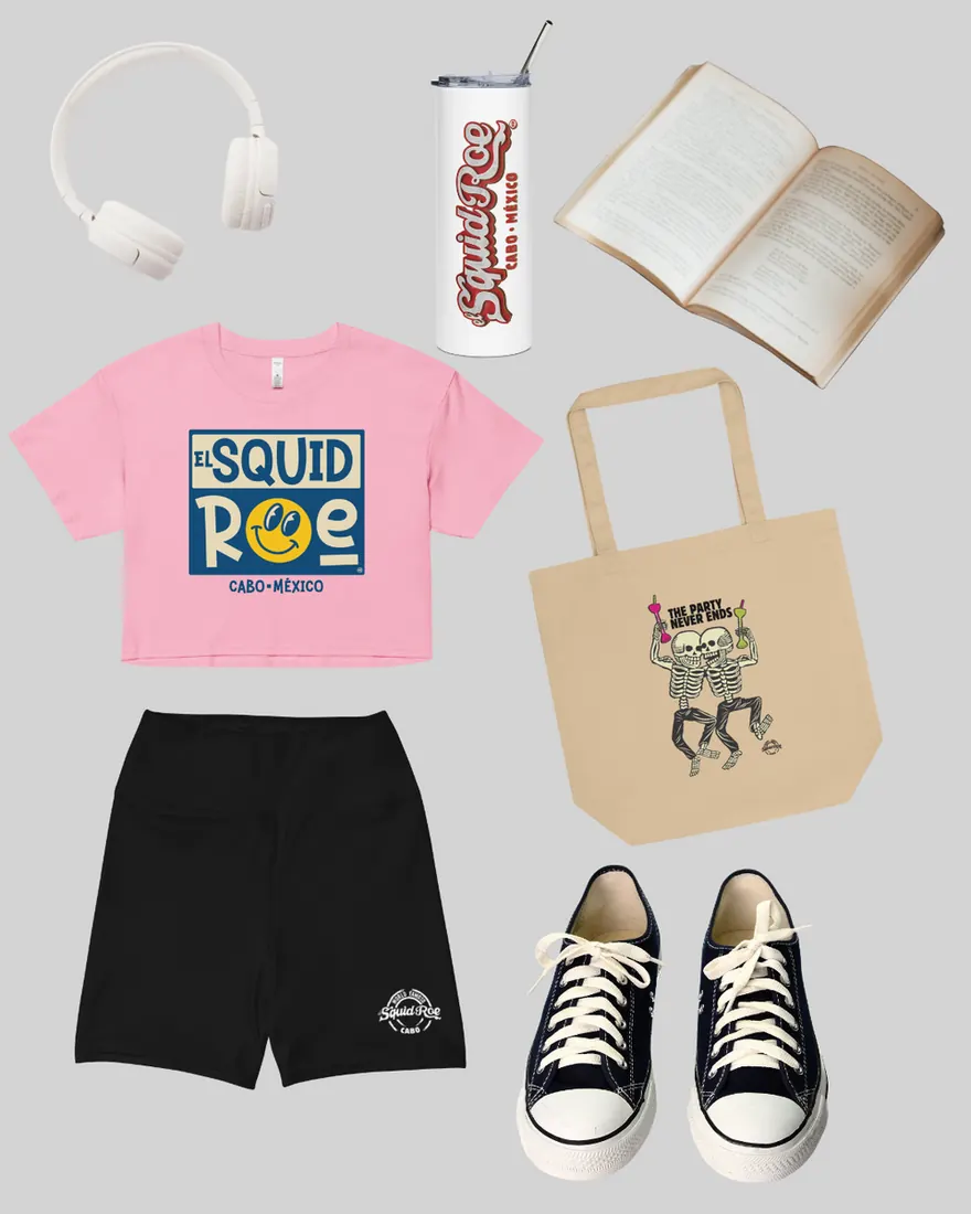 white headphones, white stainless steel tumbler with the El Squid Roe logo in red, an open book, pink crop top with a vintage smiley face design, a tan tote bag with an illustration of two skeletons dancing and drinking, black yoga shorts with "World Famoso El Squid Roe" on it, and a pair of black Converse.