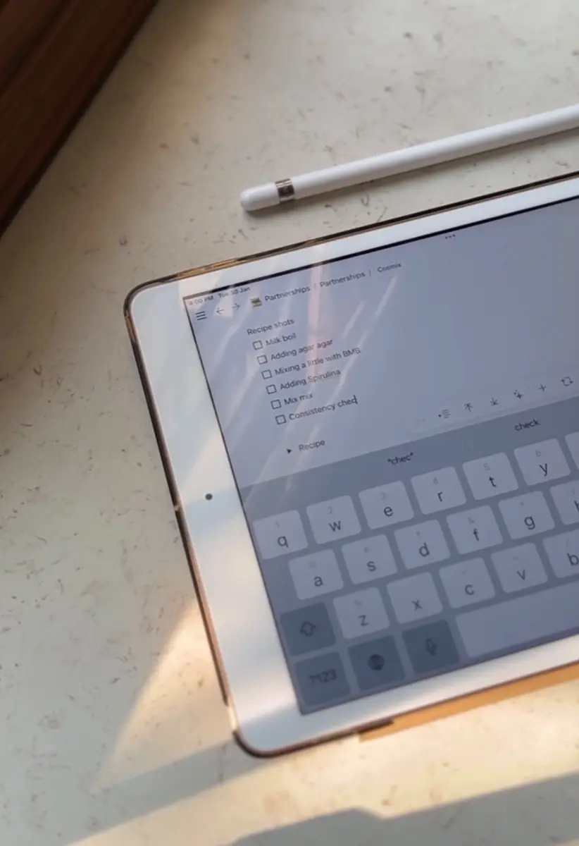 Ipad with a checklist on a marble table.